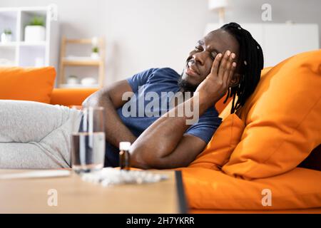Tired African American Man With Headache And Stress Stock Photo