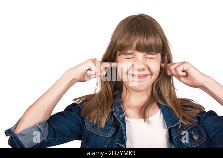 Teenager with eyes closed closes her ears with hands, isolated on white Stock Photo