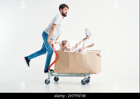 a young couple ride a cart entertainment isolated background Stock Photo