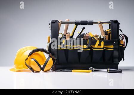Various Manual Tools And Hardware In Toolbox On Gray Background Stock Photo