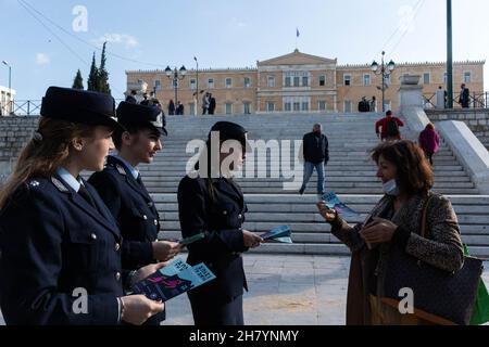 Athens, Greece. 25th Nov, 2021. Policewomen give leaflets to passersby on the International Day for the Elimination of Violence against Women in Athens, Greece, Nov. 25, 2021. Credit: Marios Lolos/Xinhua/Alamy Live News Stock Photo