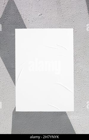 gray painted urban wall with wrinkled glued poster template Stock Photo