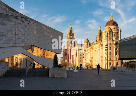 Liverpool waterfront - Pier Head, The Three Graces and Museum of Liverpool at sunset, Liverpool, England, UK Stock Photo