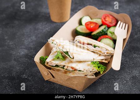 Take-out quesadilla with chicken, tomatoes and cheese. Mexican cuisine. Stock Photo