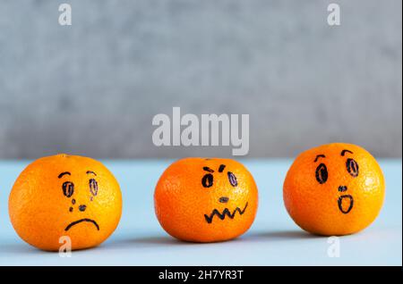 Citrus, mandarin emoji, tangerine with painted faces. Negative emotions, characters. Angry, sad, crying. Copy space Stock Photo