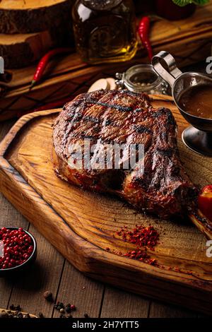 Grilled beef tomahawk steak with pepper sauce Stock Photo