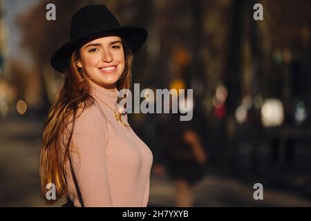 Woman smiling while standing outdoors. Stock Photo
