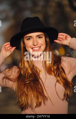 Woman smiling while standing outdoors. Stock Photo