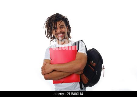 Smiling man wearing a backpack and holding a folder while standing on an isolated background. Stock Photo