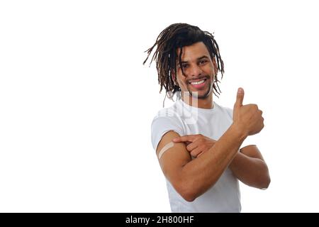 Smiling man showing thumb up after being vaccinated against Covid-19. Stock Photo