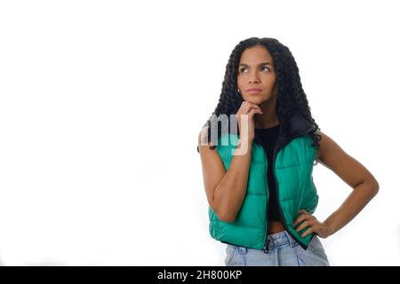 Thoughtful woman with hand on her chin and looking away while thinking something. Stock Photo