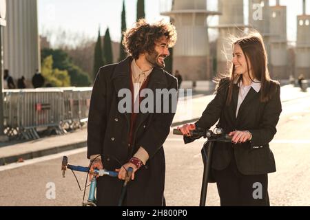 Two friends walking and laughing together outdoors. Stock Photo