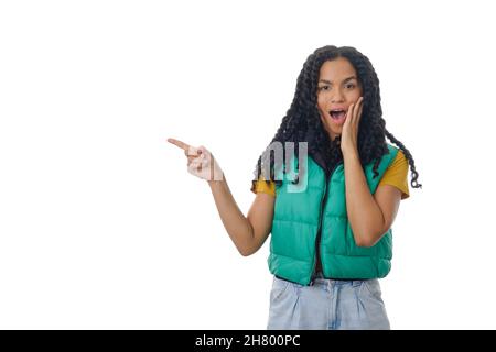 Woman with a surprised expression on her face while pointing to an empty space to show something. Stock Photo