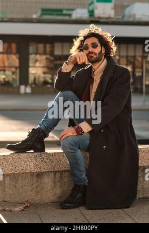 Portrait of hipster man dressed stylishly outdoors. Stock Photo