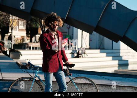 Man using his mobile phone outdoors. Stock Photo
