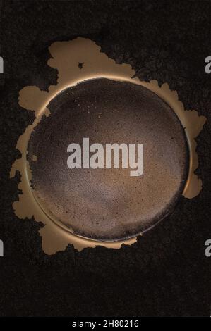 Gold glitter background. A black circle with a golden outline similar to the sun. Fluid Art for banners, ethereal graphic design. Stock Photo