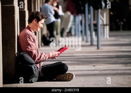 Young man using a digital tablet outdoors. Stock Photo