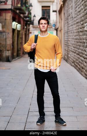 Young man standing outdoors on the street. Stock Photo