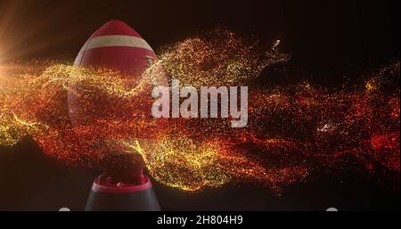 Image of glowing orange particles moving over rugby ball Stock Photo