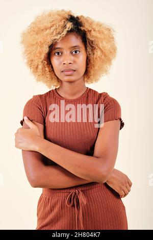 Serious afro woman posing on an isolated background. Stock Photo