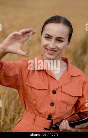 Wheat Testing Agronomist holding test tube with barley grains in field, closeup ...