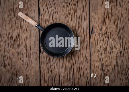 Top view Black pan on wood background Stock Photo