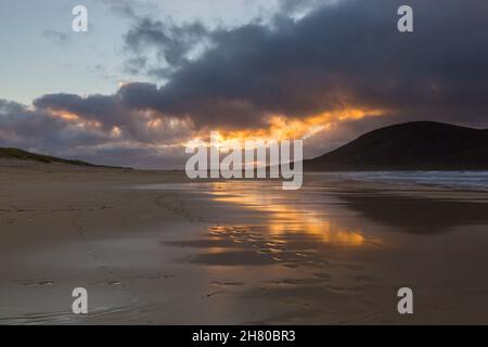 Golden sunset reflected on the seashore of Scarista Beach, Sound of Taransay, Isle of Lewis and Harris, Outer Hebrides, Scotland UK in November Stock Photo