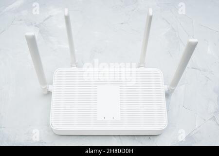 Top view of a dual band wi-fi 6 router with four antennas placed on a concrete table Stock Photo