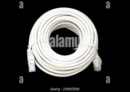Roll of ethernet patch internet cable isolated on black. Stock Photo