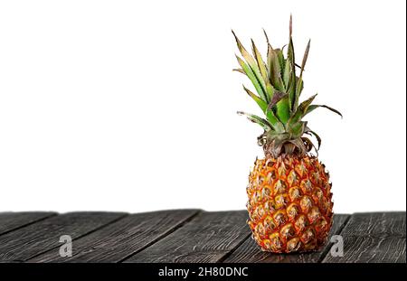Pineapple stands on wooden boards isolated on white background Stock Photo