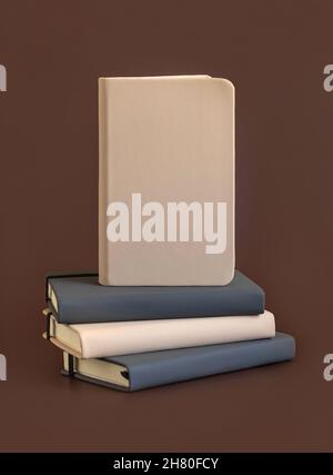Stack of beige and grey hardcover notebooks isolated on brown closeup. Textbook mockup, planner cover with place fot text. Educational, business and o Stock Photo
