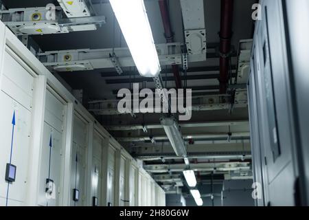 low angle view of closed servers in data center with fluorescent lamps, cyber security concept Stock Photo