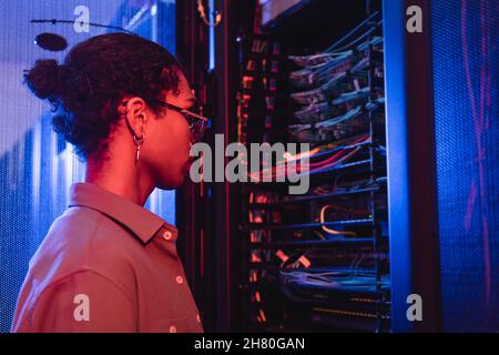 young african american engineer making diagnostics of server in data center Stock Photo