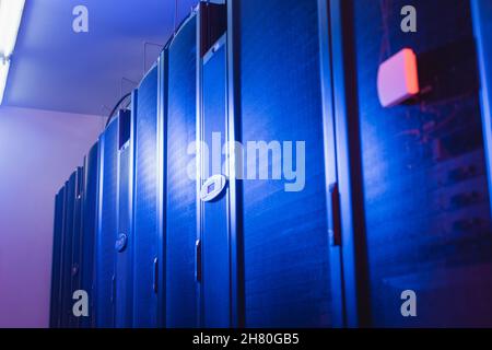 closed servers in modern data center with neon light, cyber security concept Stock Photo