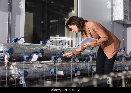 engineer with digital tablet checking cooling system of data center Stock Photo