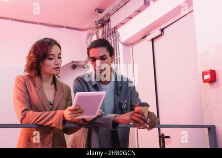 young interracial engineer with digital tablet working in data center Stock Photo