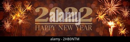 Happy New Year, New Year's Eve Party Silvester background banner panorama long- Golden yellow firework on rustic red stone concrete texture, top view Stock Photo