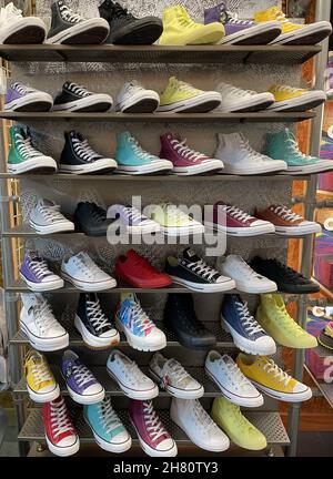 FRESN, UNITED STATES - Oct 27, 2021: A vertical shot of a store wall shelf full of Converse All-Star Canvas Shoes in different fun colors Stock Photo