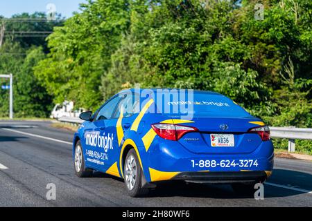 Herndon, USA - May 27, 2021: Northern Virginia Fairfax county with maid bright van for home cleaning residential service with blue yellow logo on car Stock Photo