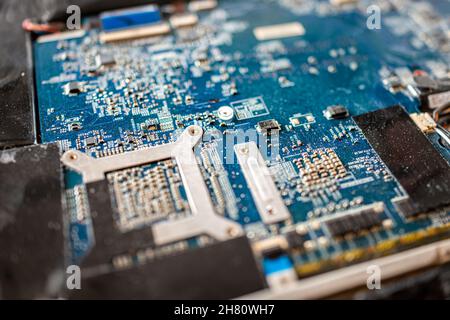 Banner Elk, USA - June 23, 2021: Macro closeup of micro chips in motherboard of open MSI laptop computer keyboard for replacing dead hard drive diy Stock Photo