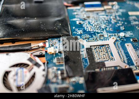 Banner Elk, USA - June 23, 2021: Macro closeup of micro chips detail, lithium ion battery and dusty fan in motherboard of open MSI laptop computer key Stock Photo