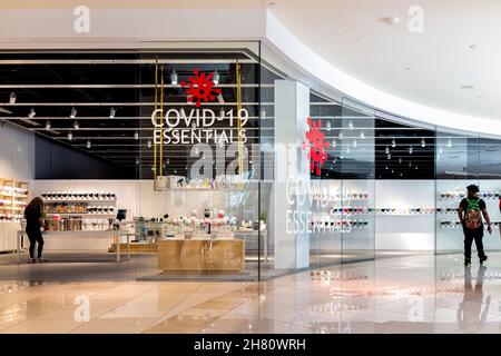Miami, USA - July 19, 2021: Sign for covid-19 essentials store shop selling masks and thermometers inside of Aventura shopping mall in Florida, United Stock Photo