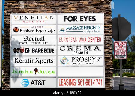 West Palm Beach, USA - July 8, 2021: Local Florida retail strip shopping mall entrance with sign for many businesses of restaurant, nail spa cafe of J Stock Photo