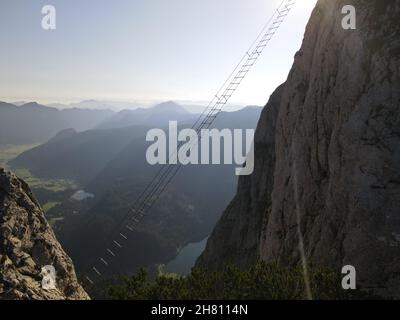 One of the most famous via ferratas in the world. The via ferrata on Donnerkogel in Austria. A ladder to the other side of the mountain . extreme Stock Photo