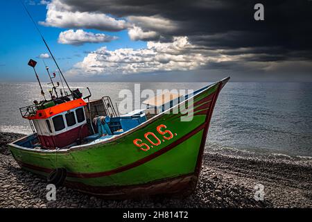 Boat stranded on the beach after a storm Stock Photo - Alamy