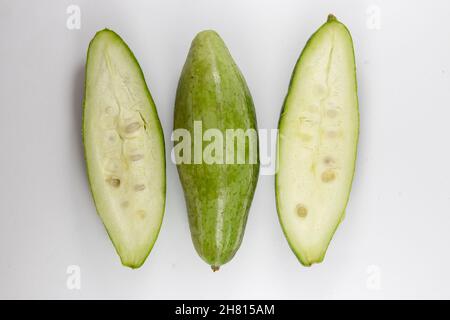 Top view of unripe healthy organic fresh pointed gourds cut in half isolated on a white background Stock Photo