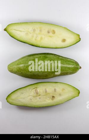 Top view of unripe healthy organic fresh pointed gourds cut in half isolated on a white background Stock Photo