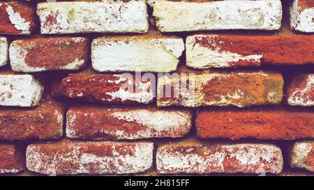 Rough brickwork with large gaps between the old red bricks Stock Photo