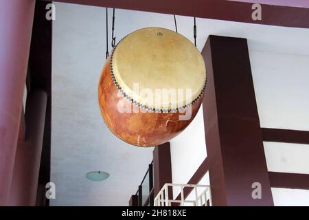 Drum hanging from a beam in a Buddhist temple. Stock Photo