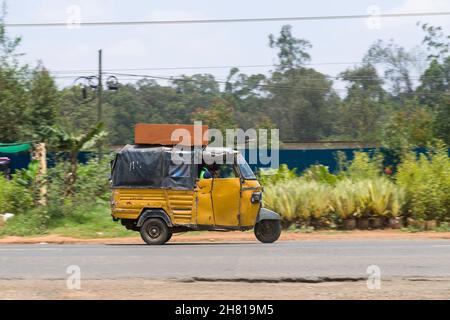 An auto rickshaw taxi which are know locally as a Tuk Tuk, they are used for passengers and goods. Ngong Road, Karen, Nairobi, Kenya.  10 Oct 2021 Stock Photo